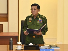 In this provided by The Myanmar Military True News Information Team on Jan. 31, 2024, Senior Gen. Min Aung Hlaing, chairman of State Administration Council, speaks during meeting with members the National Defense and Security Council in Naypyitaw, Myanmar. (The Myanmar Military True News Information Team via AP)