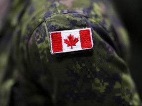 Canadian flag on military uniform.