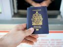 A Canada Border Services Agency photo of a traveller handing their passport to an officer at a land port of entry.