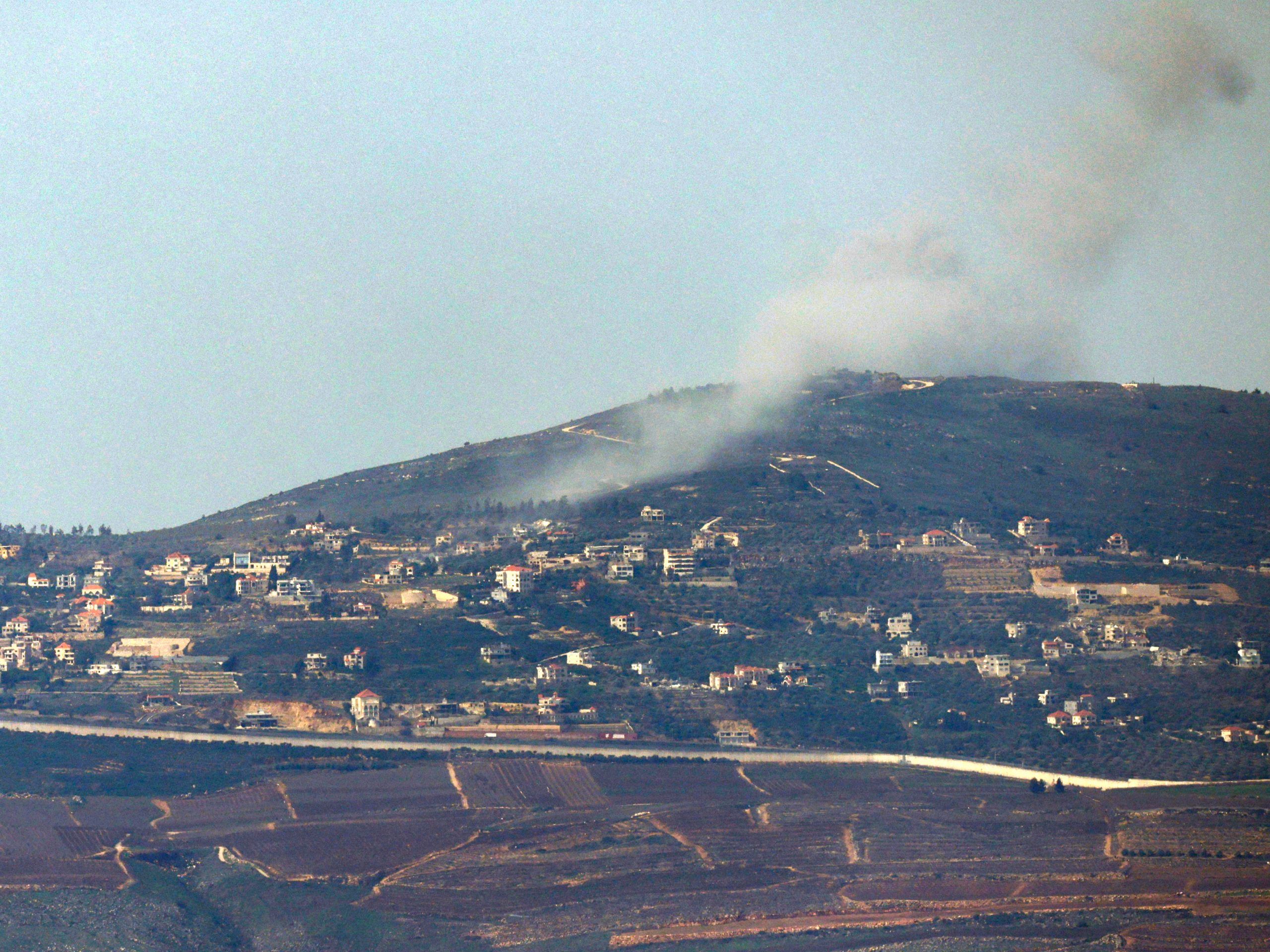 An Israeli position along the border with southern Lebanon shows smoke billowing above the Lebanese village of Adaisseh on Feb. 12, 2024. (