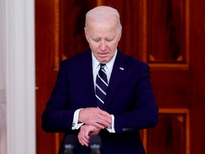 U.S. President Joe Biden checks his watch as he arrives to deliver remarks to welcome King of Jordan Abdullah II ibn Al Hussein to the White House on Feb. 12, 2024 in Washington, D.C.