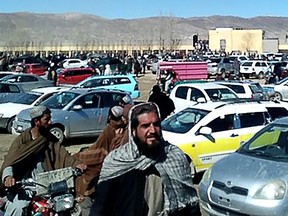 Afghan men leaving a football stadium after attending the public execution by Taliban