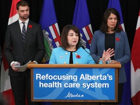 Mental Health and Addiction Minister Dan Williams, left, Health Minister Adriana LaGrange and Premier Danielle Smith outline how the province plans to refocus the health care system during a news conference in Edmonton on Nov. 8, 2023.