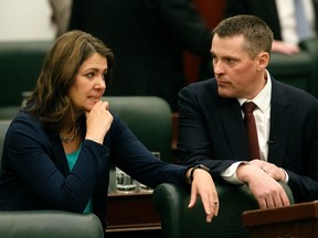 Premier Danielle Smith and Finance Minister Nate Horner chat as they arrive in the Alberta legislature chamber to deliver the 2024 provincial budget in Edmonton on Thursday, Feb. 29, 2024.