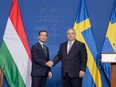 Hungary's Prime Minister Viktor Orban (R) and Swedish Prime Minister Ulf Kristersson
