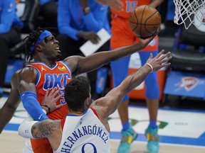 Oklahoma City Thunder forward Luguentz Dort, left, goes up for a shot in front of New Orleans Pelicans center Willy Hernangomez in Oklahoma City, in this April 29, 2021, file photo. Oklahoma City saw significant improvements from two of its young cornerstones in third-year guard Shai Gilgeous-Alexander and second-year guard Lu Dort.