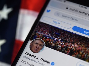 In this file photo illustration taken on Aug. 10, 2020, the Twitter account of U.S. President Donald Trump is displayed on a mobile phone in Arlington, Virginia