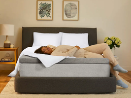 Woman laying down on Casper mattress with mattress topper