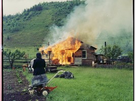 Woman watching a house burn