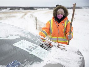 A missing poster in the window of her car, Ashley Brown prepares to search along the Salmon River on Jan. 9, 2022.