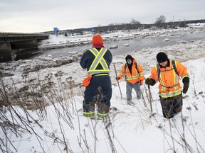 Jason Ehler, centre, with friends Reg and Dennis Hare, searching on Jan. 9, 2022.