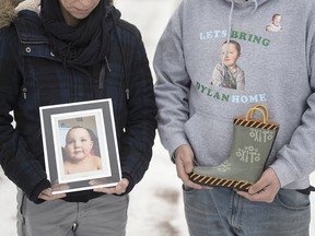 Ashley Brown, left, and Jason Ehler, on Jan. 9, 2022 with a photo of their missing son, Dylan, and a boot he was wearing when he disappeared.