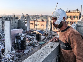 An injured man overlooks the rubble of a destroyed building in Rafah, in the southern Gaza Strip, on Feb. 7, 2024, amid the ongoing war between Israel and the Hamas terrorist group.