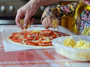Making homemade pizza is an affordable (and delicious) way to have fun with the family.