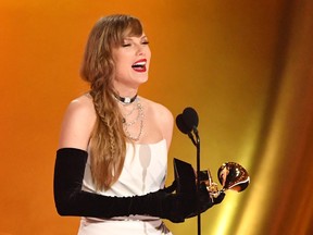 Taylor Swift accepts a Grammy Award.