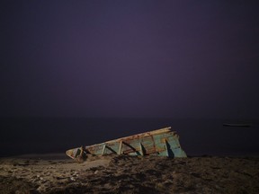 FILE - The wreck of a traditional Mauritanian fishing boat, known as a pirogue, also used by migrants to reach Spain's Canary Islands, sits on a beach near Nouadhibou, Mauritania, on Dec. 2, 2021. The head of the EU's executive branch, Commission President Ursula von der Leyen, and Spain's Prime Minister Pedro Sánchez are visiting the African nation of Mauritania to discuss migration, security and energy with the African nation's President Mohamed Ould Ghazouani. The visit takes amid a surge in the number of migrants embarking on a dangerous Atlantic crossing from the coast of Mauritania to Spain's Canary Islands.