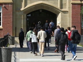 High school students head into a school.