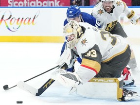 Vegas Golden Knights goaltender Adin Hill saves a shot from Toronto Maple Leafs' Mitchell Marner during second period NHL hockey action in Toronto, on Tuesday, February 27, 2024.THE CANADIAN PRESS/Chris Young