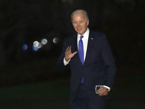 President Joe Biden waves as he walks across the South Lawn of the White House in Washington, Wednesday, Feb. 7, 2024, after returning from New York where he attended three fundraisers.