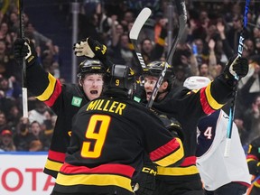 Vancouver Canucks' Brock Boeser, back left, Pius Suter, back right, and J.T. Miller celebrate Boeser's third goal against the Columbus Blue Jackets during the third period of an NHL hockey game in Vancouver, on Saturday, January 27, 2024. Boeser has spoken over the years about wanting to crack the 30 goal mark after going close in his first season with the Vancouver Canucks.THE CANADIAN PRESS/Darryl Dyck