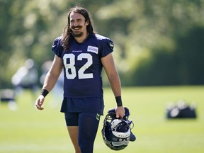Seattle Seahawks tight end Luke Willson carries his helmet after NFL football training camp, Friday, Aug. 14, 2020, in Renton, Wash. The 34-year-old LaSalle, Ont., native held the Lombardi Trophy in 2014 as a rookie tight end after Seattle's 43-8 win over the Denver Broncos. But that euphoria turned to despair the following year when the New England Patriots rallied to beat the Seahawks 28-24.