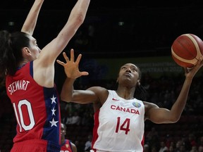 Canada's Kayla Alexander, right, lays up for a shot at goal as United States' Breanna Stewart attempts to block during their semifinal game at the women's Basketball World Cup in Sydney, Australia, Friday, Sept. 30, 2022. Alexander led the way with 15 points and 13 rebounds as Canada took a 67-55 opening win over host Hungary on Thursday in a FIBA Olympic Qualifying tournament.THE CANADIAN PRESS/AP-Mark Baker