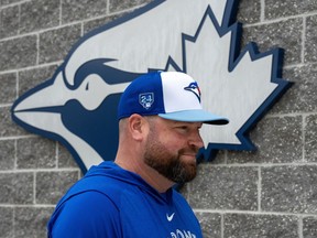 Toronto Blue Jays manager John Schneider walks into the clubhouse after meeting with media at the Jays Spring Training complex in Dunedin, Fla. on Thursday, February 15, 2024.