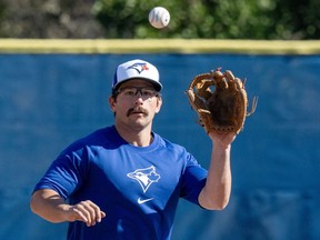 Toronto Blue Jays Davis Schneider fields a ball in Spring Training action in Dunedin, Fla. on Wednesday, February 21, 2024.&ampnbsp;Schneider is getting his first taste of big-league training camp even though he's no longer a rookie.&ampnbsp;THE CANADIAN PRESS/Frank Gunn
