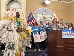 California Democratic state Sen. Catherine Blakespear gestures toward a person covered in plastic bags during a news conference at the Capitol in Sacramento, Calif., on Thursday, Feb. 8, 2024. Blakespear has authored a bill that would ban all plastic shopping bags in California.