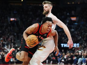 Toronto Raptors forward Scottie Barnes (left) is fouled by Cleveland Cavaliers forward Dean Wade (32) during first half NBA basketball action in Toronto on Saturday, Feb. 10, 2024.