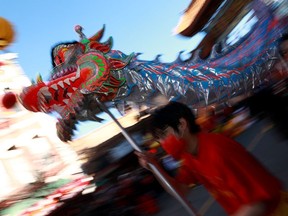 Progressive and LGBTQ+ groups say they've been excluded from Vancouver's Lunar New Year parade in Chinatown, with one organizer saying they were ousted for "political affiliations." Performers carry a dragon as people gather to celebrate Lunar New Year celebrations in Victoria, B.C., Sunday, Jan. 29, 2023.