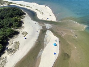 This Aug. 2022 image released by the National Parks Service, shows an illegal diversion of the Platte River into Lake Michigan at Sleeping Bear Dunes National Lakeshore, Mich. A man accused of diverting a national park river to ease boat access to Lake Michigan has been convicted of two misdemeanors. Andrew Howard, of Frankfort, was found guilty of tampering and vandalism Wednesday, Feb. 7, 2024, during a brief trial in front of U.S. Magistrate Judge Ray Kent. (National Parks Service via AP)
