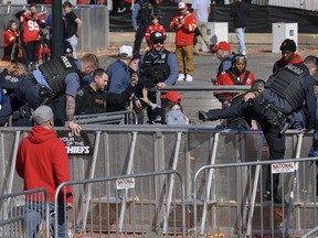 Law enforcement personnel investigate following a shooting at the Kansas City Chiefs NFL football Super Bowl celebration in Kansas City, Mo., Wednesday, Feb. 14, 2024. Multiple people were injured, a fire official said.