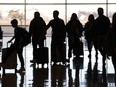 Silhouette of passengers waiting to board a plane