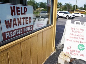 FILE - A "Help Wanted" sign is displayed in Deerfield, Ill., Wednesday, Sept. 21, 2022. The year looks to be a much better one for the U.S. economy than business economists were forecasting just a few months earlier, according to a survey released Monday, Feb. 26, 2024.
