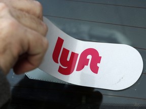 FILE - In this Jan. 31, 2018, file photo, a Lyft logo is installed on a Lyft driver's car in Pittsburgh. Lyft shares jumped 62% after the bell Tuesday, Feb. 13, 2024 thanks in part to a typo in the the ride-hailing company's earnings release that sent investors' auto-trading algorithms -- also known as "bots" -- into a buying frenzy.