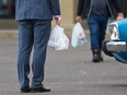 People carrying plastic bags.