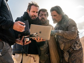 From left, Denis Villeneuve, Javier Bardem and Josh Brolin on the set of Dune: Part 2.