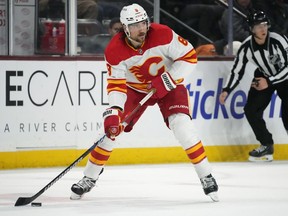 Calgary Flames defenceman Chris Tanev looks to pass the puck against the Arizona Coyotes during the second period of an NHL hockey game Thursday, Jan. 11, 2024, in Tempe, Ariz.