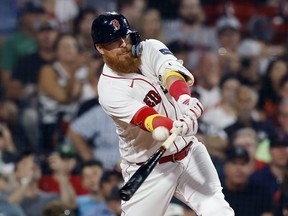 Boston Red Sox's Justin Turner hits an RBI double during the sixth inning of a baseball game against the Baltimore Orioles, Friday, Sept. 8, 2023, in Boston. Turner says it's hard to wrap your head around playing for an entire country, but he's looking forward to getting a chance with the Toronto Blue Jays.