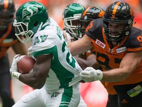 Saskatchewan Roughriders' Greg Morris, left, carries the ball past B.C. Lions' Craig Roh during the first half of a CFL football game in Vancouver, B.C., on Saturday August 5, 2017. Defensive lineman Craig Roh, who won a Grey Cup with the Winnipeg Blue Bombers in 2019, has died.