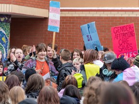 People take part in a student-led walkout at Victoria School for the Arts on Wednesday, Feb. 7, 2024, in response to the provincial government's recent announcement around transgender policies including pronoun use and preferred names.