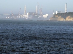 FILE - The Fukushima Daiichi nuclear power plant, damaged by a massive March 11, 2011, earthquake and tsunami, is seen from the nearby Ukedo fishing port in Namie town, northeastern Japan, on Aug. 24, 2023. The operator of the wrecked Fukushima Daiichi nuclear power plant said there is no safety worries or change to the plant's decommissioning plans even though the deadly Jan. 1, 2024 earthquake in Japan's north-central region caused some damages to a local idled nuclear plant, which rekindled safety concerns and prompted a regulatory body to order a close examination.