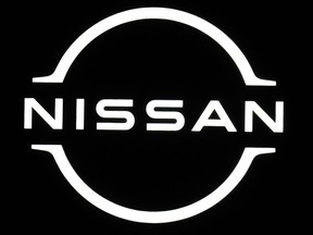 FILE - Logo of Nissan is seen at the Japan Mobility Show in Tokyo, on Oct. 26, 2023. Nissan's profit sank in October-December to about half of what it earned the year before, the automaker said Thursday, Feb. 8, 2024, though it stuck to its earlier earnings forecasts.