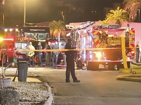 In this image made from video, fire engine, firefighters and other officials are seen inside police tape on scene of a small plane crash in Clearwater, Florida, Feb. 1, 2024.(WFTS-TV via AP)