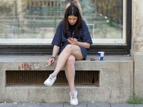 Woman with cigarette and smartphone
