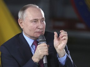 Russian President Vladimir Putin speaks to students and employees of the Chelyabinsk Forge-and-Press Plant in Chelyabinsk, Russia, Friday, Feb. 16, 2024.