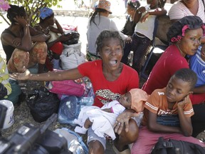Women and children gather outside a police station after fleeing their homes in Cite Soleil due to gang violence, in Port-au-Prince, Haiti, Monday, Feb. 12, 2024.