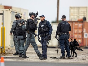 Police use a canine unit and members of the emergency response unit to search a shipping container warehouse site on Brydges Street in London after reports of an active shooter at the location. This site is only a few blocks from the gold dealership location that was robbed Thursday morning. No one was found on the scene, but police did report four people were arrested in the Woodstock area.