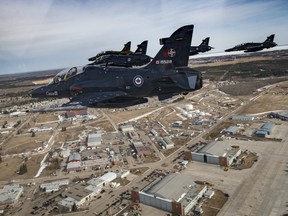 The Royal Canadian Air Force's CF-188 Hornets and CT-155 Hawks fly over the city of Cold Lake on April 1, 2021.